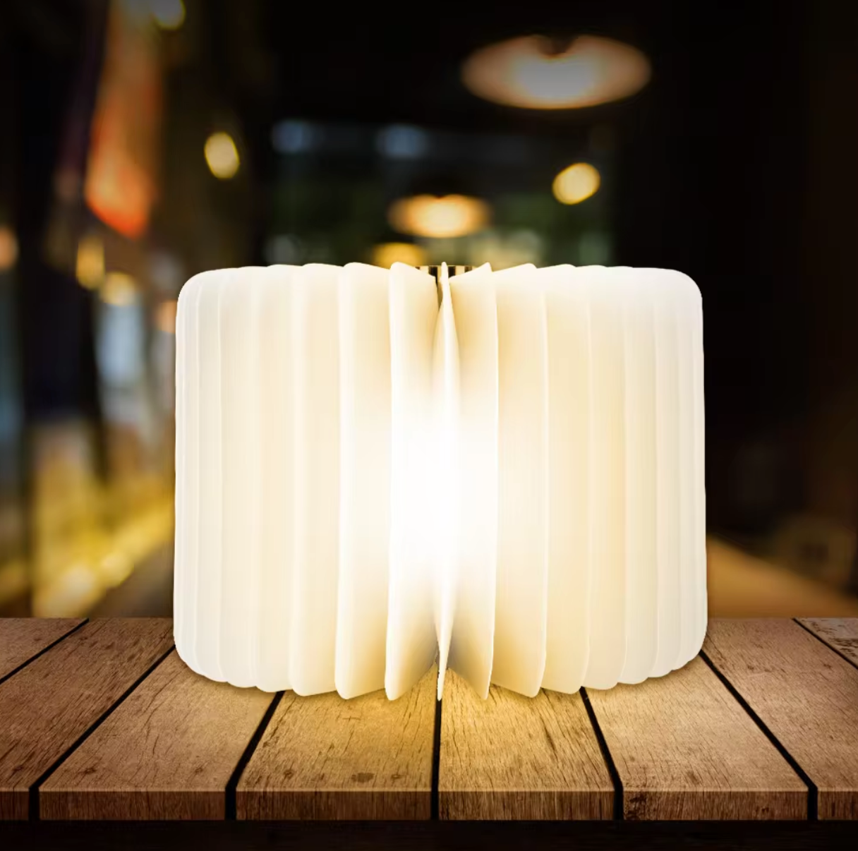 LED Wooden Book Lamp fully opened, emitting white light in a 360-degree pattern in a scenic view - Eagalite