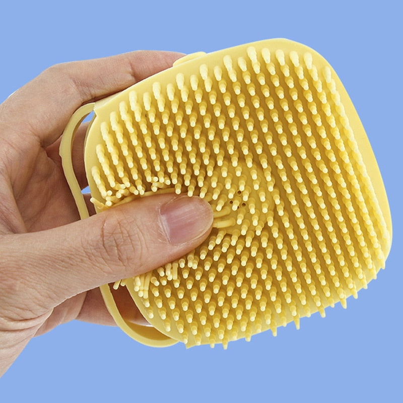 Yellow Puppy Dog Bath Shampoo Brush Being Squished By A Hand, Showing It's Sturdiness - Eagalite