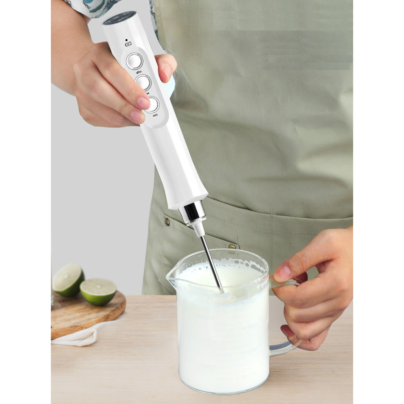 Handheld electric milk frother in action, creating frothy milk - Eagalite