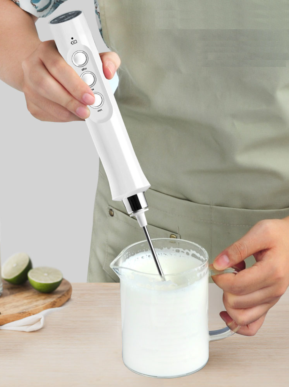 Handheld electric milk frother in action, creating frothy milk - Eagalite